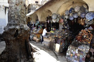 Market scene in Place Neijarine with artisanal ceramics and traditional goods, Fez, Fès-Boulemane,