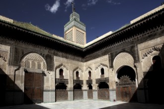 Medersa Bou Inania courtyard with arcades and blue sky in the background, Fez, Fès-Boulemane,