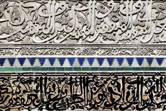Detailed mosaics and arabesques with artistic Arabic characters in the Medersa Attarine, Fez,
