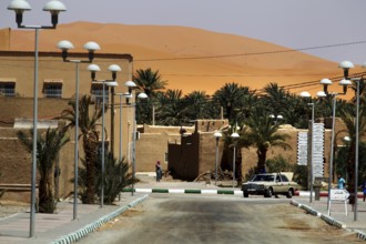 Urban area near Merzouga with traditional buildings and desert sand, Merzouga, Morocco