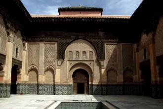 The magnificent courtyard of Medersa Ben Youssef with ornate architectural elements, Marrakech,