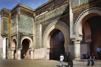 Detailed patterns on a large, impressive gate, people nearby, Meknes, Fès-Meknes, Morocco