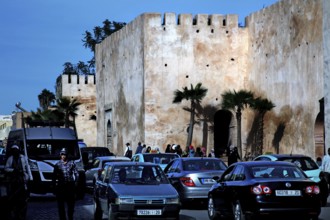 City scene with massive walls and busy car traffic in the foreground, Meknès, Fès-Meknes, Morocco