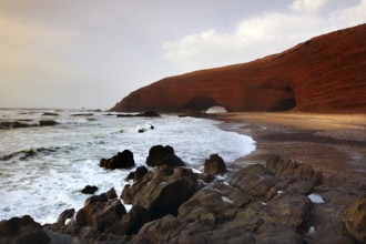 Spectacular rock arch on Legzira beach surrounded by sea and coast, Legzira, Morocco