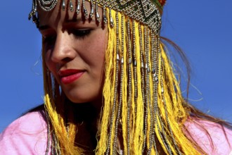 Close-up of a woman wearing a traditional headdress at the Berber festival, Ma El Kelâa m'Gouna,