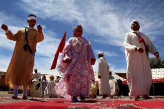 Scene of men wearing traditional Berber clothes during a celebratory dance performance, El Kelâa
