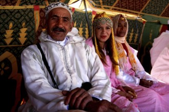 Traditional clothing and cultural atmosphere in the participant tent at the Fête des Roses, El