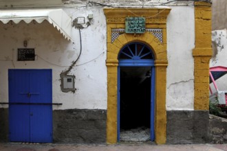 Historic façade with distinctive blue and yellow door frame in the old town, Essaouira,