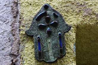 Hamsa hand relief as a decorative element on a wall in Essaouira, Essaouira, Morocco