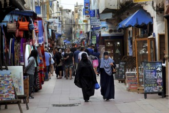 Bustling market street in Essaouira souk with many passers-by, Essaouira, Morocco
