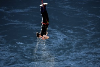 Jumpers diving headfirst into water from lofty heights, Queenstown, Otago, New Zealand