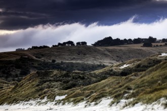 Wide dune landscape in Sandfly Bay with dramatic skies on the Otago Peninsula, Sandfly Bay, New