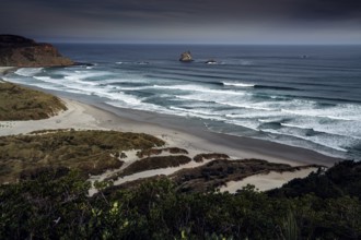 Wide coastal landscape of Sandfly Bay with rolling waves and calm sea, zero