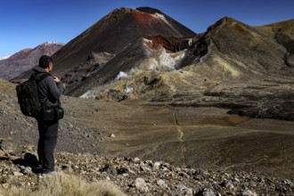 Hiker looking at Mount Ruapehu, Tongariro and Ngauruhoe, Tongariro National Park, North Island, New