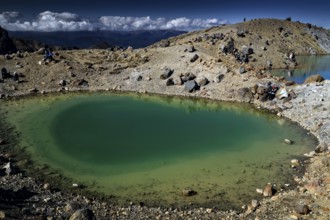 The Emerald Lakes glow turquoise green in a harsh, rocky environment, Tongariro National Park, New