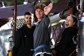 Person in front of bungee jump smiling surrounded by friends at Kawarau Bridge, Queenstown, Kawarau