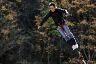 Free fall person bungee jumping in autumn, Queenstown, Otago, New Zealand