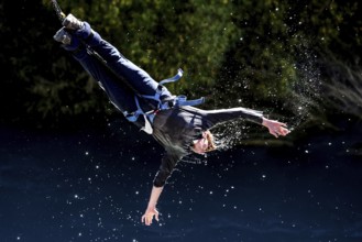 Jumpers bungee jumping touches the water of the Kawarau River, Queenstown, Kawarau Bridge, New