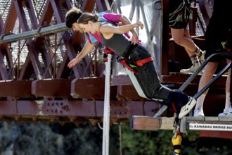 Person boldly jumps off Kawarau Bridge while bungee jumping, Queenstown, Otago, New Zealand