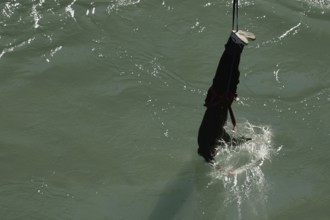 Single bungee jumper approaches the water of Kawarau Gorge, Queenstown, Otago, New Zealand
