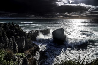 Moonlight over Pancake Rocks in Punakaiki, lined with powerful ocean waves, Punakaiki, West Coast,