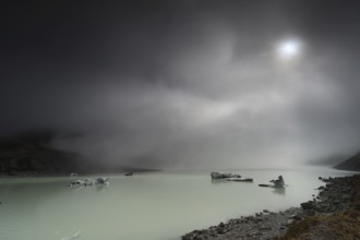 Night view of a glacial lake under cloudy sky in Aoraki National Park, Mt Cook, Hocker Valley