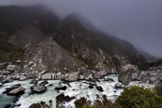 Rocky mountain landscape in fog with wild river in Hocker Valley, New Zealand, zero