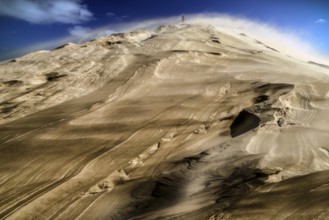 Dramatic Te Paki sand dune in sandstorm under blue sky, Ninety Mile Beach, Te Paki, New Zealand