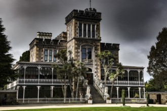Neo-Gothic castle with stone façade on the Otago Peninsula under gloomy skies, Otago Peninsula, New