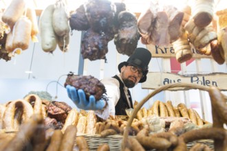 An exhibitor presents sausages from Poland at the Green Week at the exhibition center in Berlin on