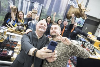 Two men take pictures of themselves at the Estonian stand at the Green Week at the exhibition