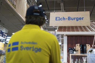 A sign indicates the sale of elk burgers at Sweden's stand at the Green Week at the exhibition