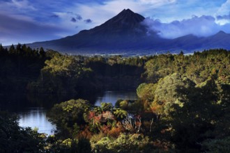 Mount Taranaki above Lake Mangamahoe, surrounded by lush green nature, New Zealand, zero