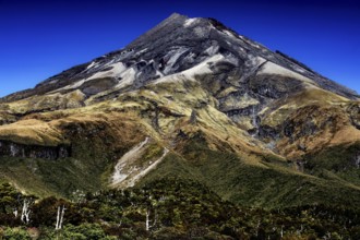 Impressive view of the summit of Mount Taranaki under clear blue skies in Mt Egmont National Park,