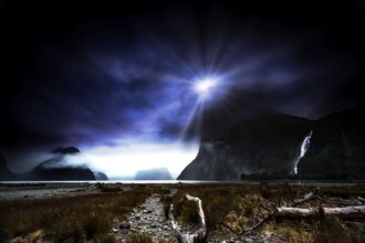 Glowing moonrays plunge Milford Sound into a mysterious atmosphere and illuminate the landscape,