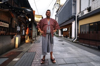 Man in yukata posing on a quiet street in Yamanouchi, Yamanouchi, Japan