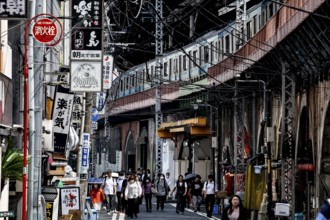Bustling street scene in Chuo with numerous people and shops, Tokyo, Japan