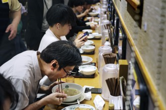 Guests enjoy ramen at a busy restaurant in Tokyo, Tokyo, Hamamatsucho, Japan
