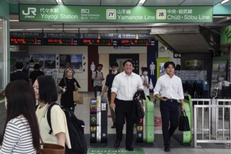 Entrance of a busy train station with commuters in Tokyo, Tokyo, Japan