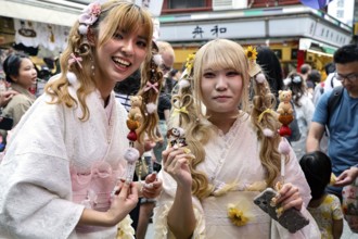 Two woman wearing white kimonos smile in Asakusa, Tokyo, Asakusa, Japan