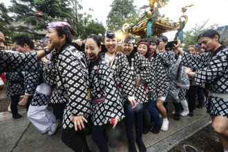 Participants laugh wildly in traditional clothing at Sanja Matsuri, Tokyo, Asakusa, Japan