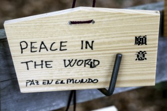 Wooden wish plate at Meiji Shrine in Tokyo with wish for peace inscribed in English, Tokyo, Japan