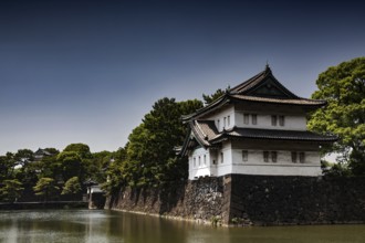 Imperial Palace wall with adjacent moat in peaceful surroundings, Tokyo, Japan