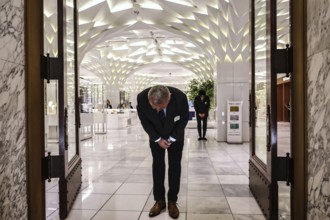 Employees bowing traditionally to open a shop, Tokyo, Nihombashi, Japan