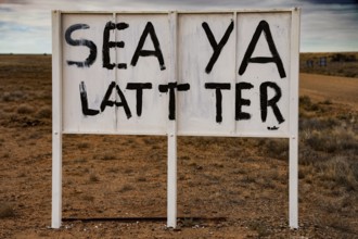 Ironic sign in a lonely desert area, dry and funny atmosphere, zero