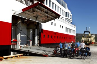 Cyclists enter the Hurtigruten ship via the tailgate in Kirkenes, Kirkenes, Finnmark, Norway