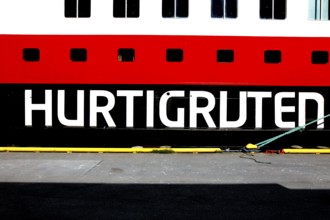 Hurtigruten lettering on a ship against a blue sky in Hammerfest, Hammerfest, Norway