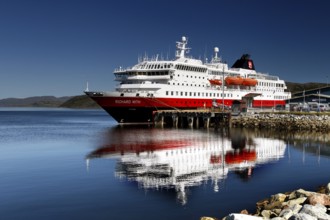 Hurtigruten ship reflected in the water off the coast of Kirkenes, Kirkenes, Finnmark, Norway