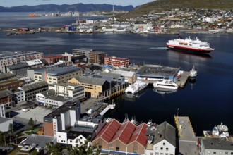 Hurtigruten ship docks in the busy port of Hammerfest, Hammerfest, Finnmark, Norway
