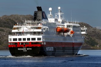 Hurtigruten ship sails through rocky landscape, Kirkenes, Finnmark, Norway
